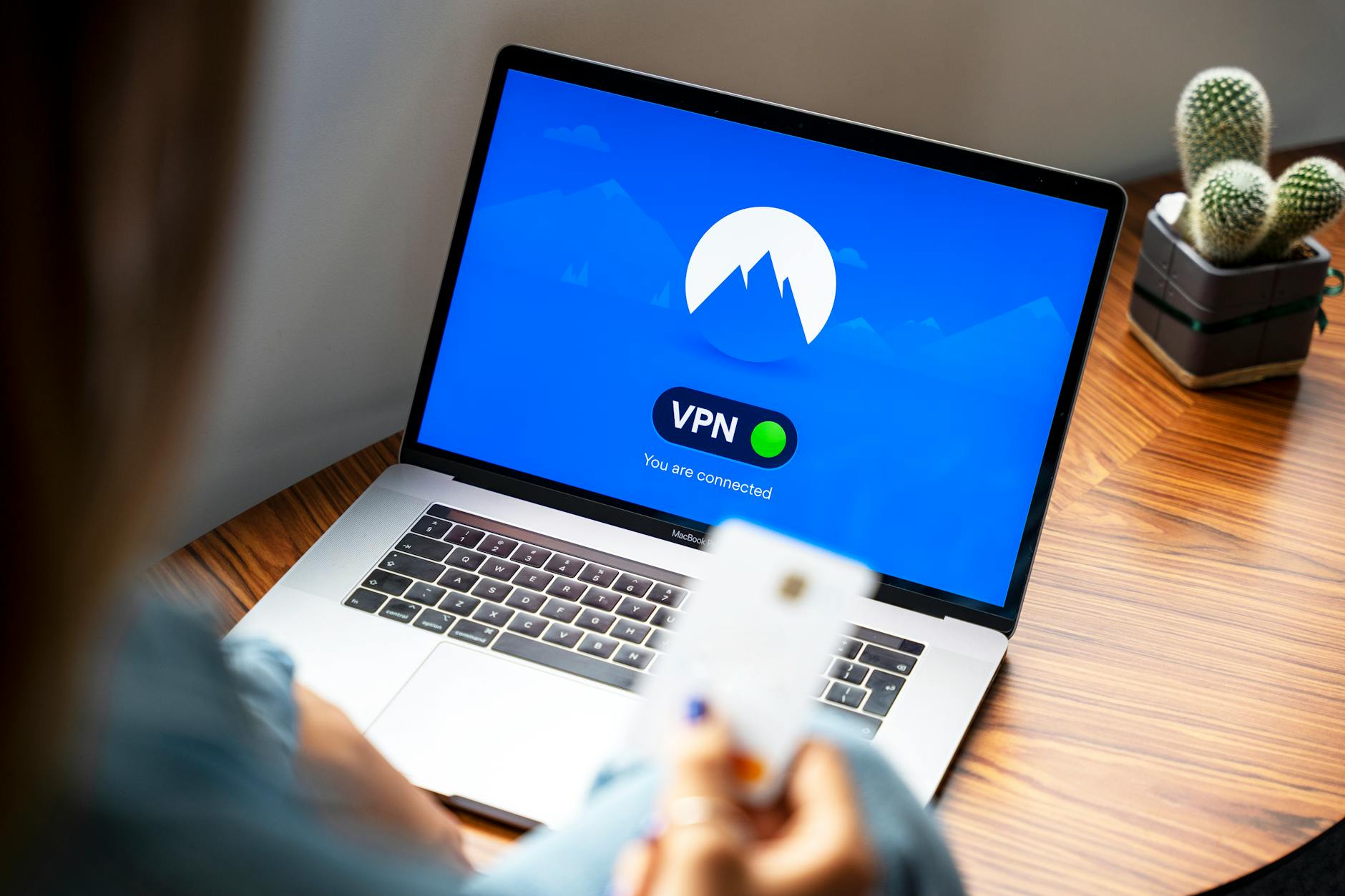 Jak bezpiecznie udostępniać pulpity przez internet: RDP, SSH, tunelowanie i VPN w realnych scenariuszach Osoba korzystająca z VPN na laptopie w nowoczesnym wnętrzu