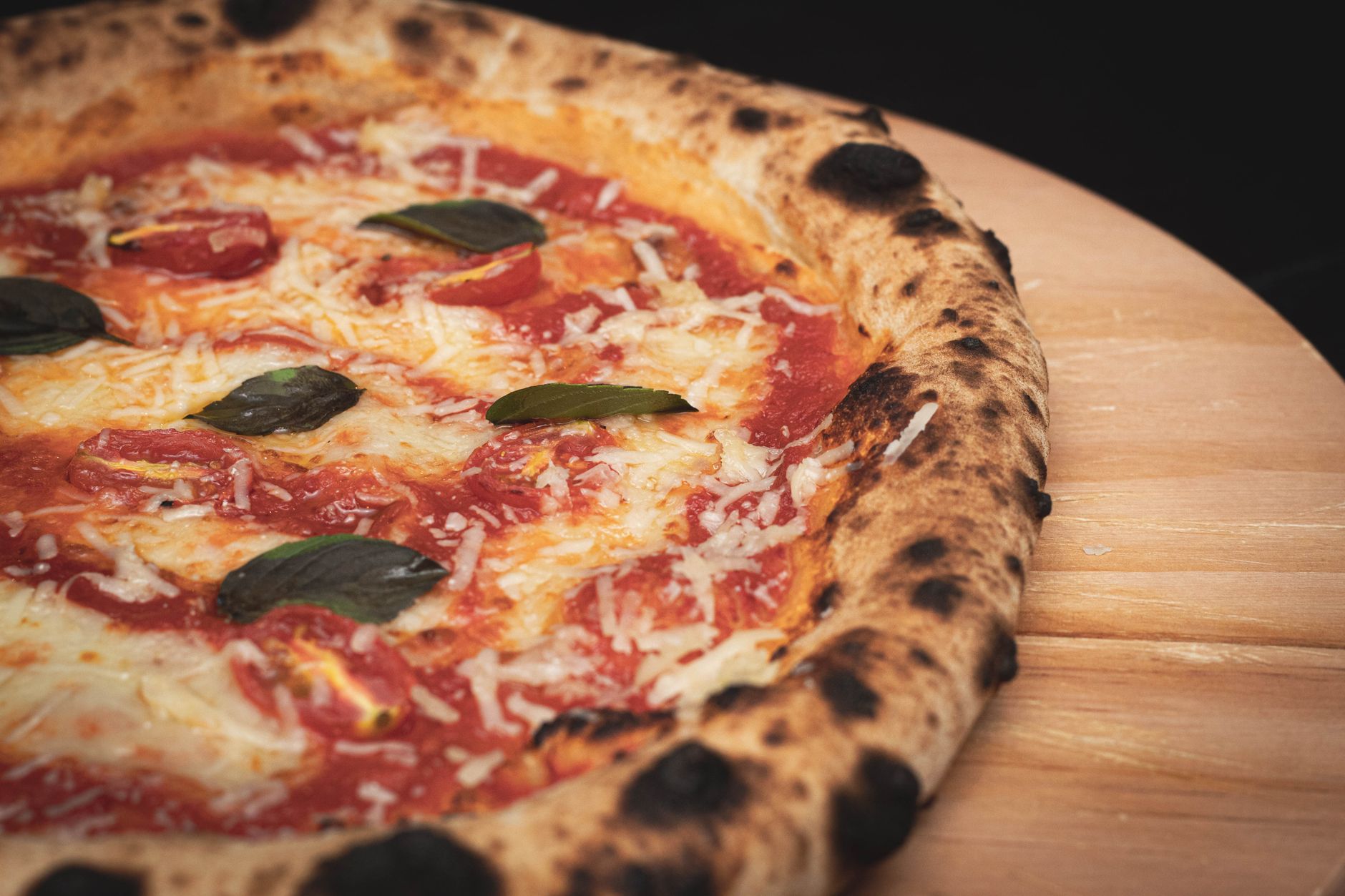 Zbliżenie na świeżo upieczoną pizzę Margherita na drewnianej desce